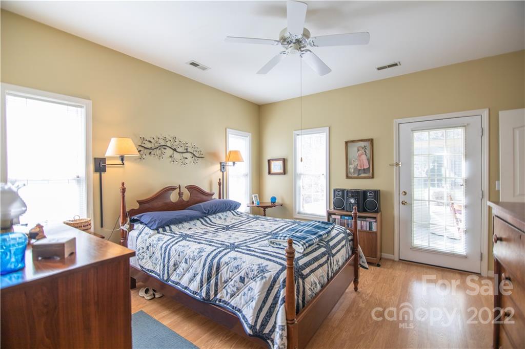 7 Sheffield Place Brevard, NC 28712 - Photo 13 of 30 a bedroom with a bed and a table with chair