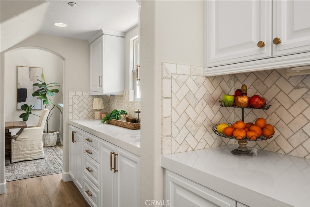 4 Lewiston Court Ladera Ranch, CA 92694 - Photo 8 of 48 a kitchen with white cabinets and wooden floor