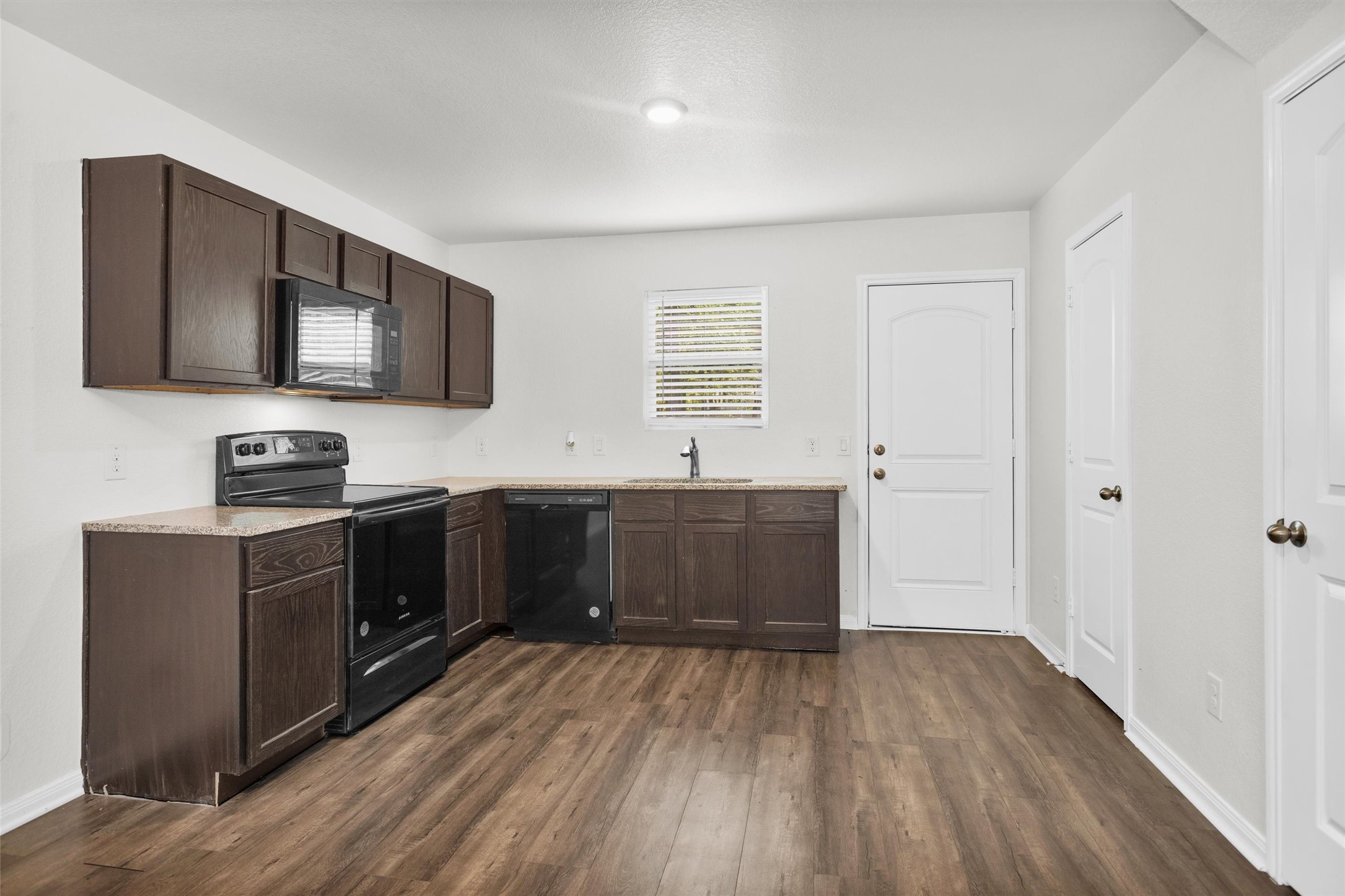 15134 Austin Road Willis, TX 77378 - Photo 8 of 20 a kitchen with stainless steel appliances granite countertop a stove a sink and a refrigerator