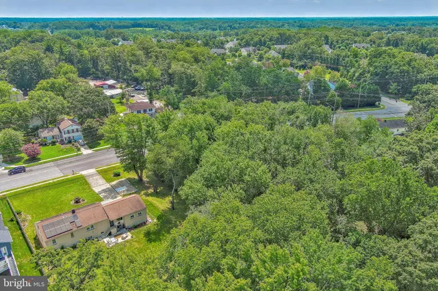 an aerial view of a houses with a yard