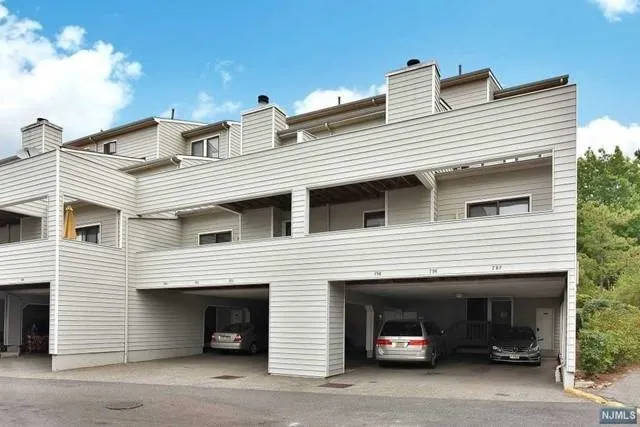 a view of house and car parked in front of house