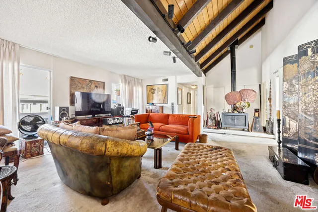 a living room with furniture fireplace and a window