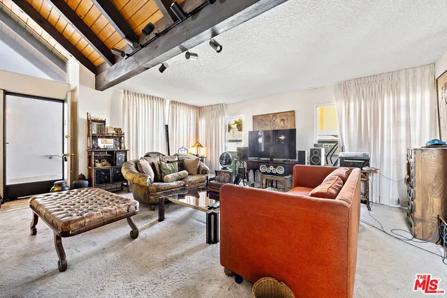 a living room with furniture a rug and a window