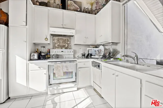 a kitchen with stainless steel appliances granite countertop a sink and cabinets