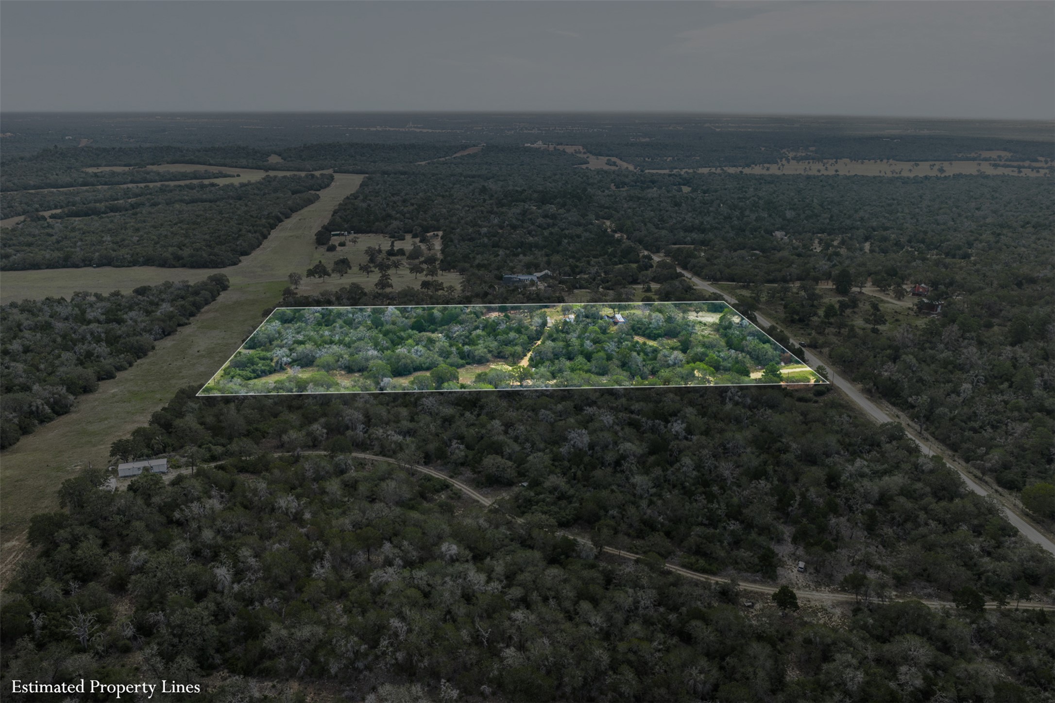 3301 Chuckwagon Road Harwood, TX 78632 - Photo 20 of 36 A sweeping aerial view showcases the vast, wooded acreage with clearly defined boundaries.