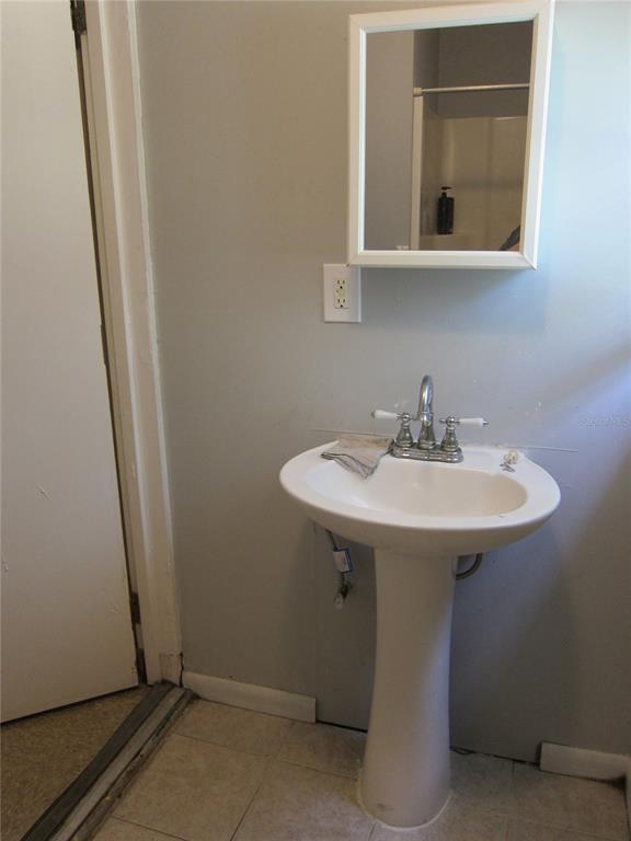 1602 Southwest Williston Road, Unit A Gainesville, FL 32608 - Photo 8 of 8 a sink and a mirror