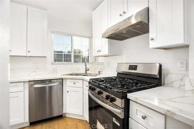 a kitchen with cabinets and stainless steel appliances