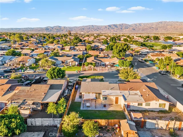 an aerial view of a building with a swimming pool