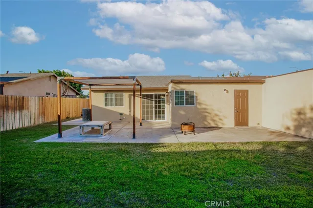 a couple of table and chairs in front of house