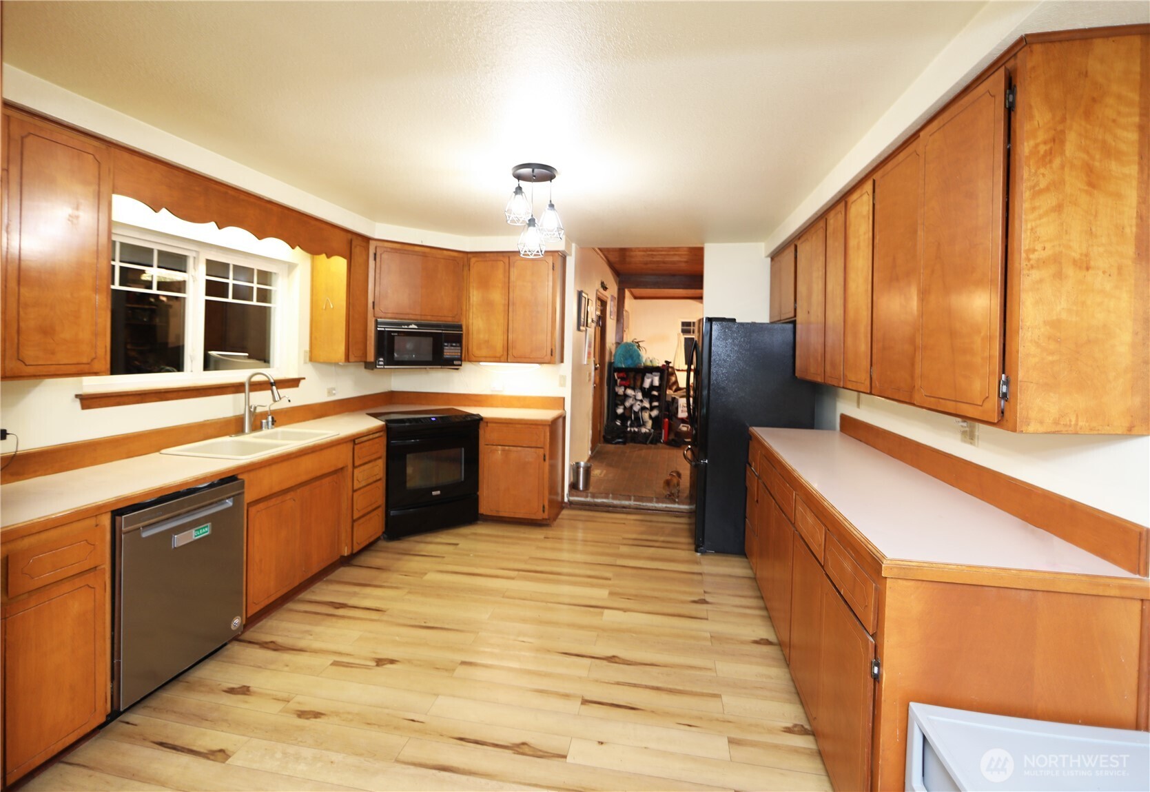 3619 Shincke Road Northeast Olympia, WA 98506 - Photo 21 of 28 a large kitchen with a large counter top space a sink stainless steel appliances and cabinets