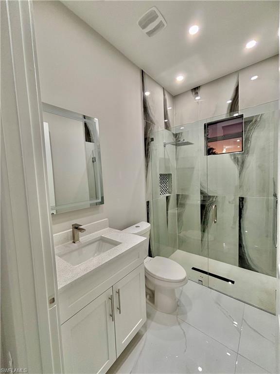 3904 12th Street Southwest Lehigh Acres, FL 33976 - Photo 11 of 12 a bathroom with a sink a toilet and shower