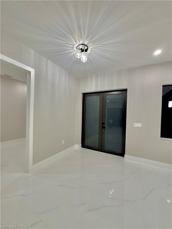 3904 12th Street Southwest Lehigh Acres, FL 33976 - Photo 2 of 12 a view of an empty room with a ceiling fan