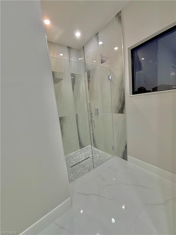 3904 12th Street Southwest Lehigh Acres, FL 33976 - Photo 8 of 12 a bathroom with a shower and a sink