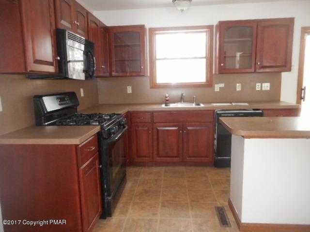 713 Buckle Boot Road Henryville, PA 18332 - Photo 3 of 12 a kitchen with a stove top oven sink and cabinets