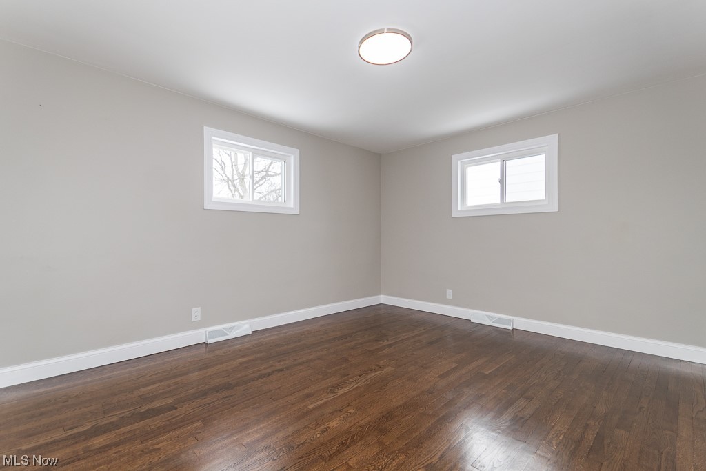 4980 Emmet Road Lyndhurst, OH 44124 - Photo 15 of 39 Empty room with dark wood-type flooring and a healthy amount of sunlight