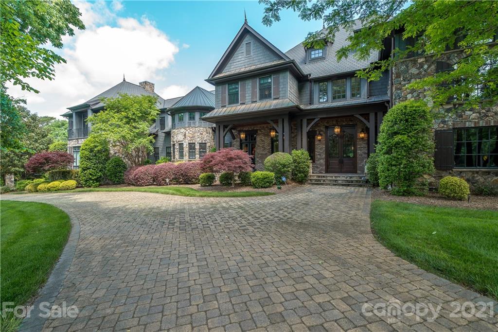 a front view of a house with a yard and plants