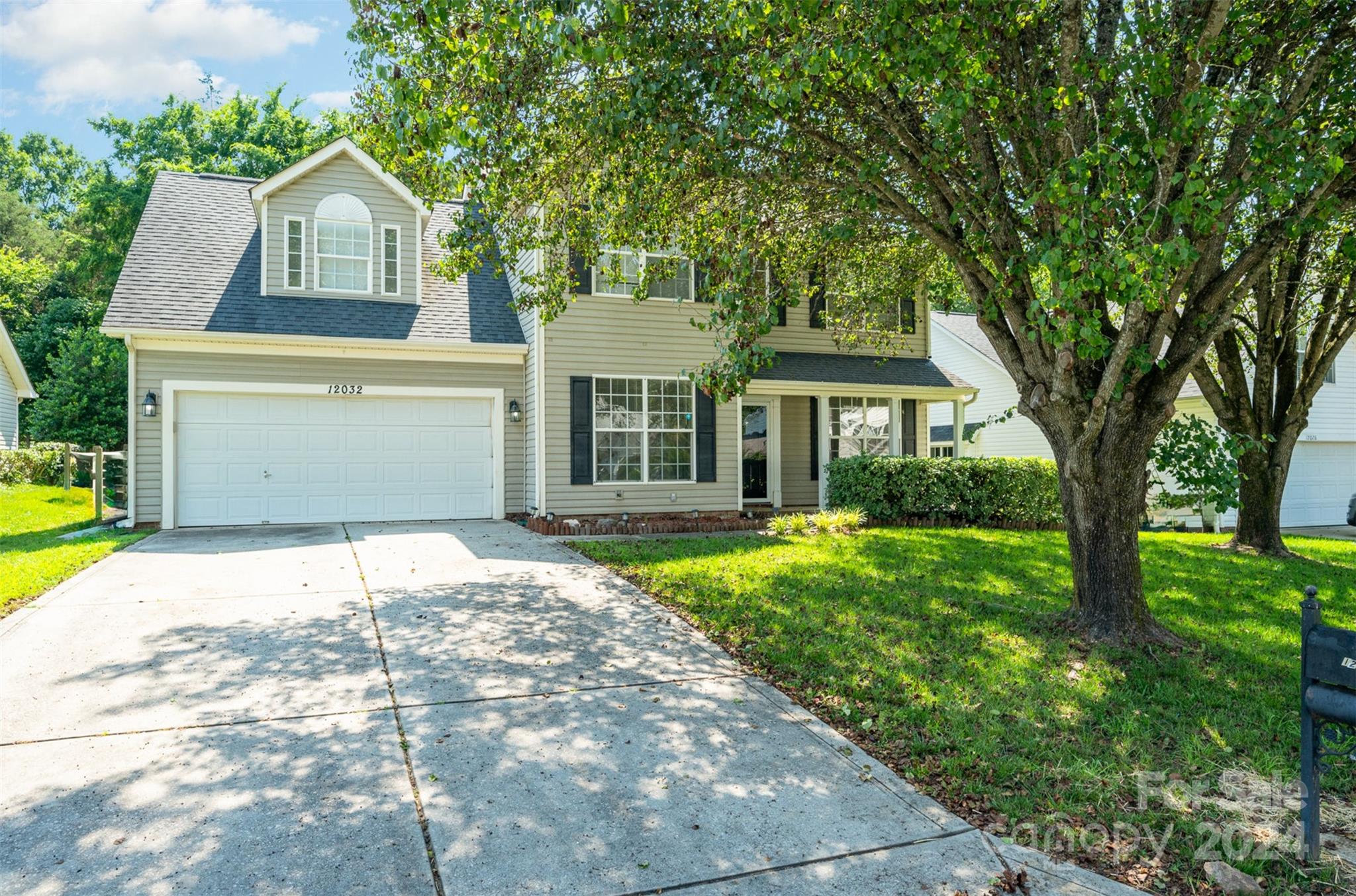 12032 Regent Ridge Lane Charlotte, NC 28278 - Photo 1 of 25 a front view of a house with garden
