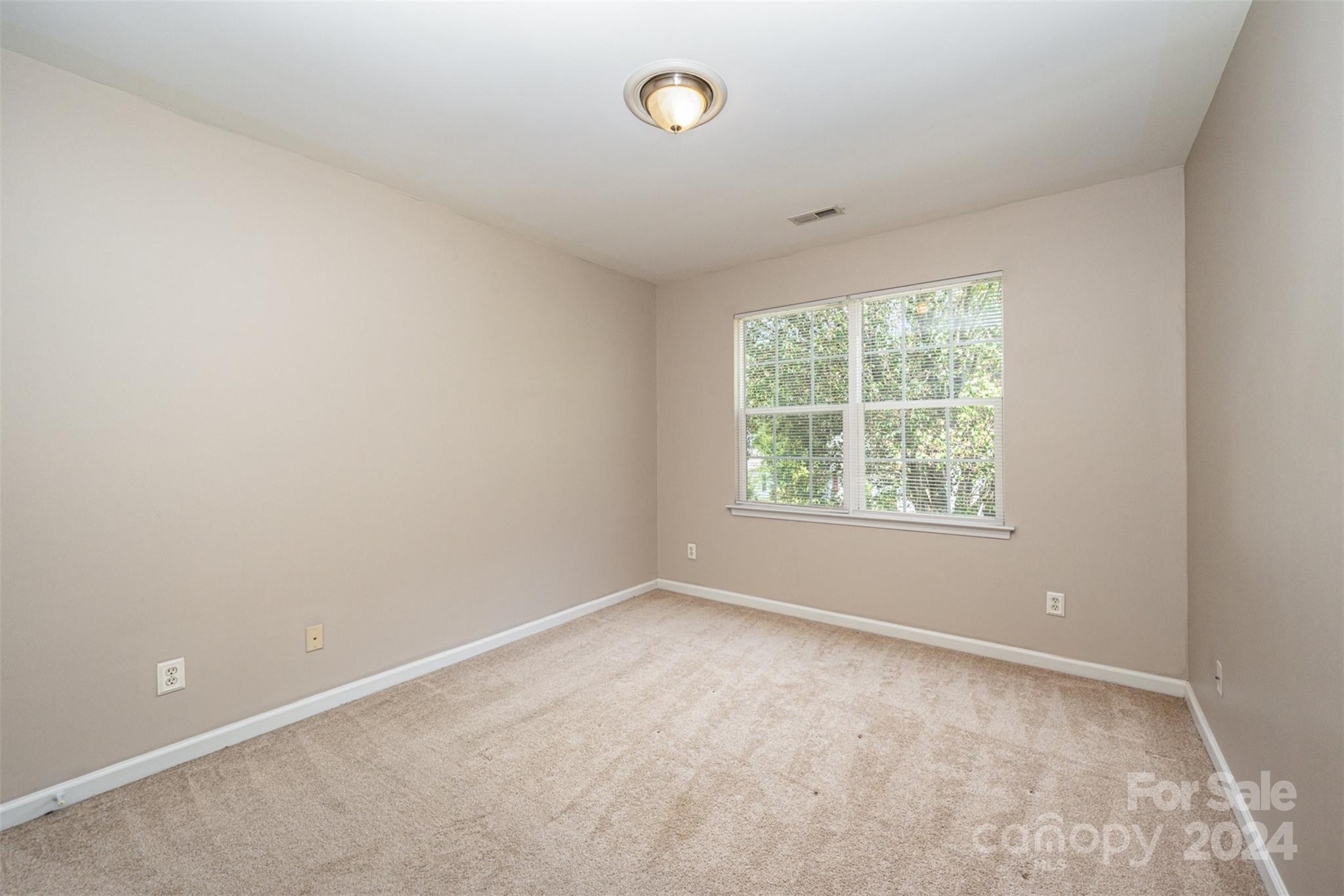 12032 Regent Ridge Lane Charlotte, NC 28278 - Photo 16 of 25 an empty room with a window