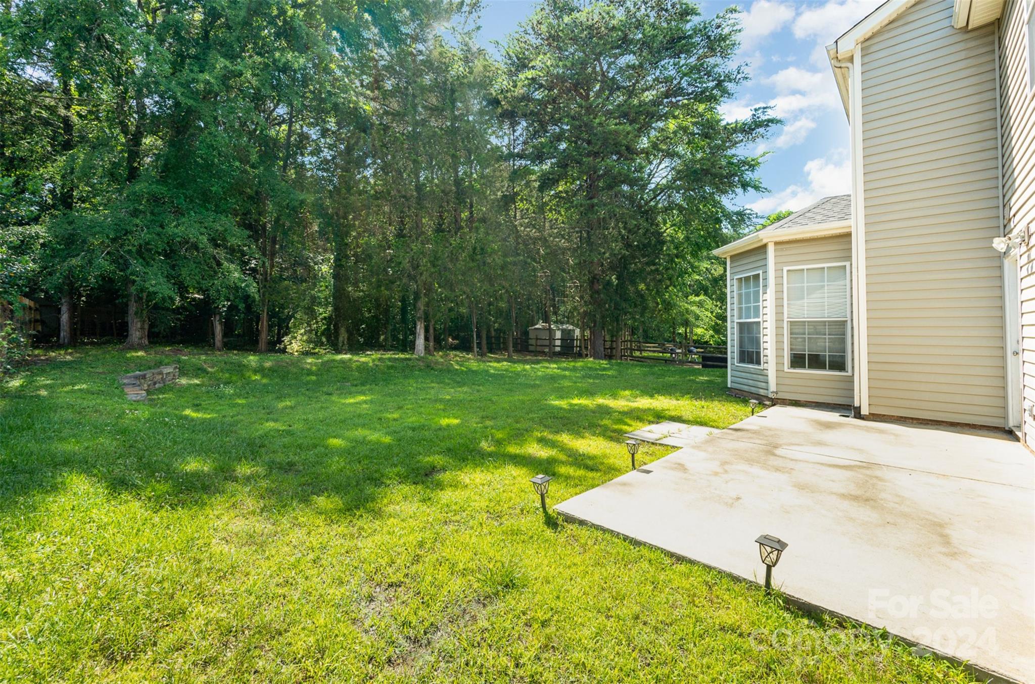 12032 Regent Ridge Lane Charlotte, NC 28278 - Photo 20 of 25 a view of a backyard with a garden and trees