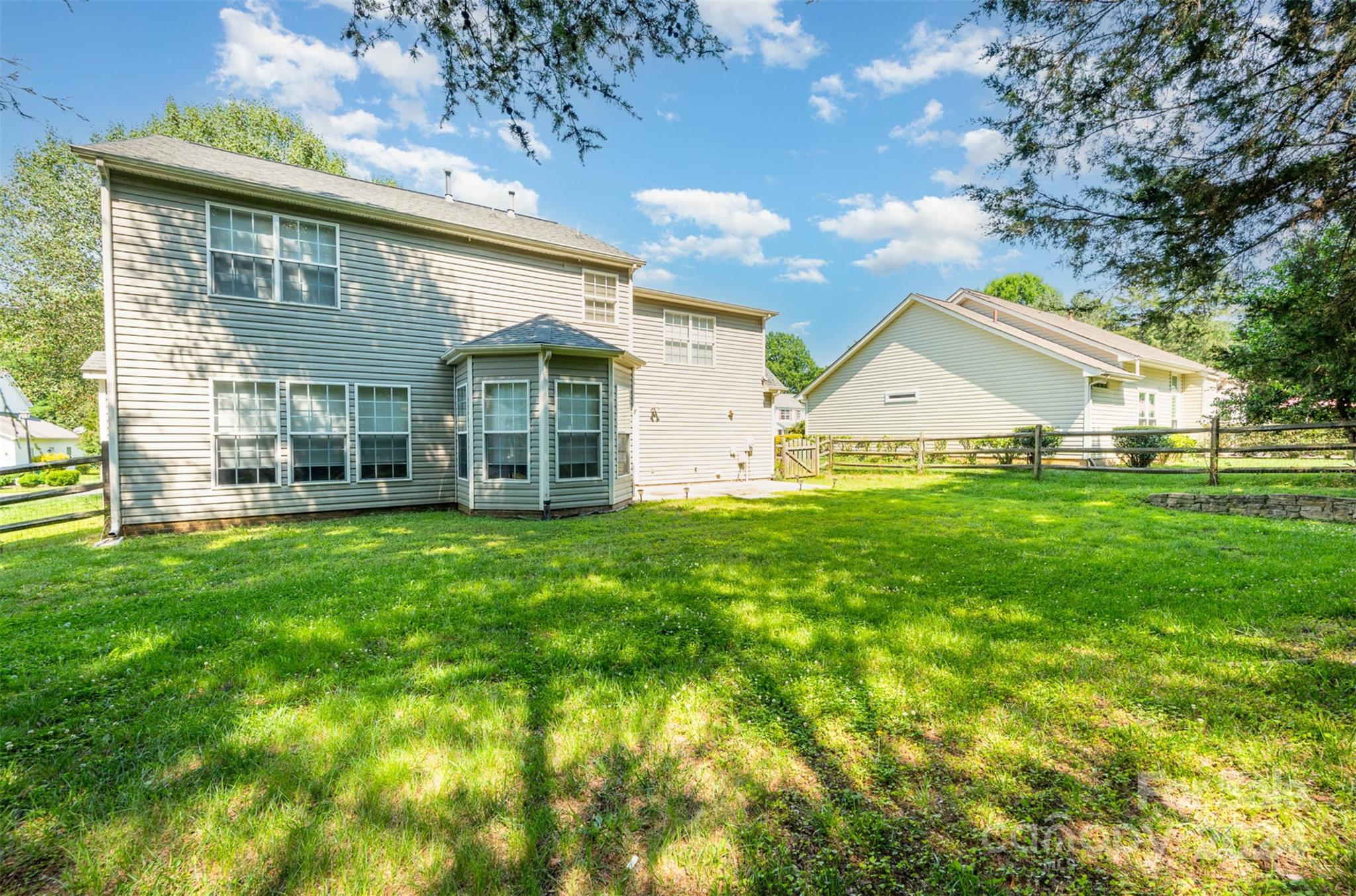 12032 Regent Ridge Lane Charlotte, NC 28278 - Photo 23 of 25 a view of a house with a yard