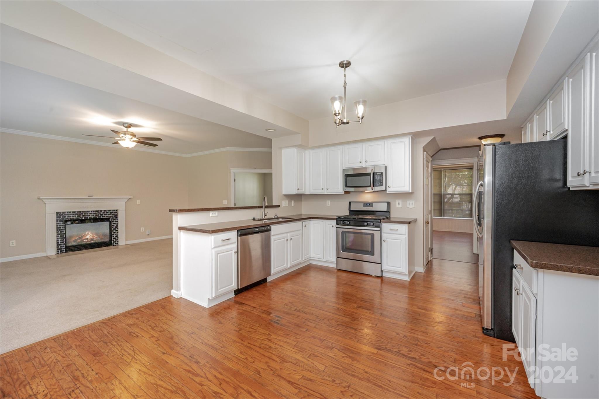 12032 Regent Ridge Lane Charlotte, NC 28278 - Photo 6 of 25 a large kitchen with cabinets wooden floor and stainless steel appliances