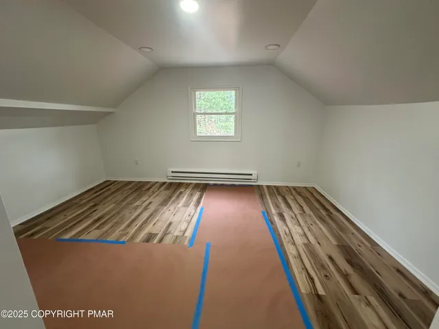 an empty room with wooden floor