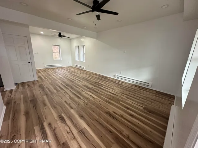 wooden floor in an empty room with a window