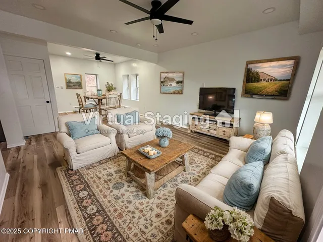 a living room with furniture a flat screen tv and a couch