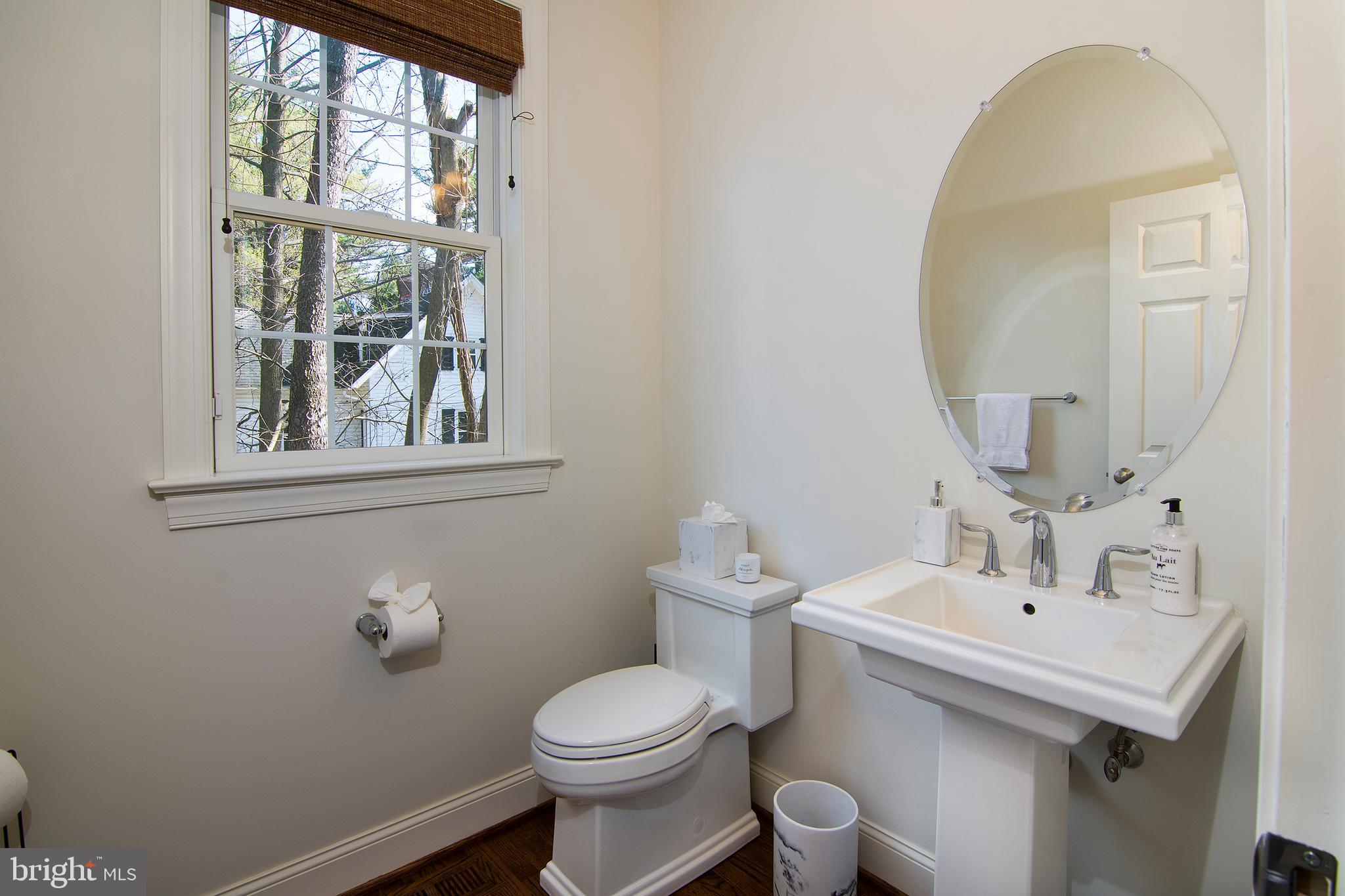 1428 County Line Road Bryn Mawr, PA 19010 - Photo 17 of 31 a bathroom with a toilet sink and mirror