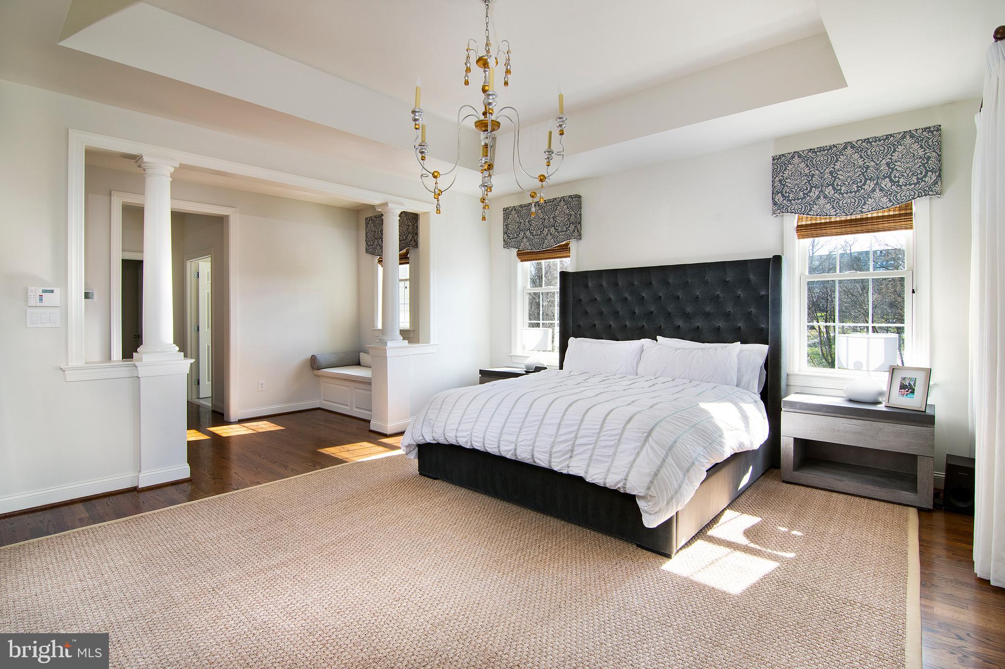 1428 County Line Road Bryn Mawr, PA 19010 - Photo 18 of 31 a spacious bedroom with a bed and a chandelier
