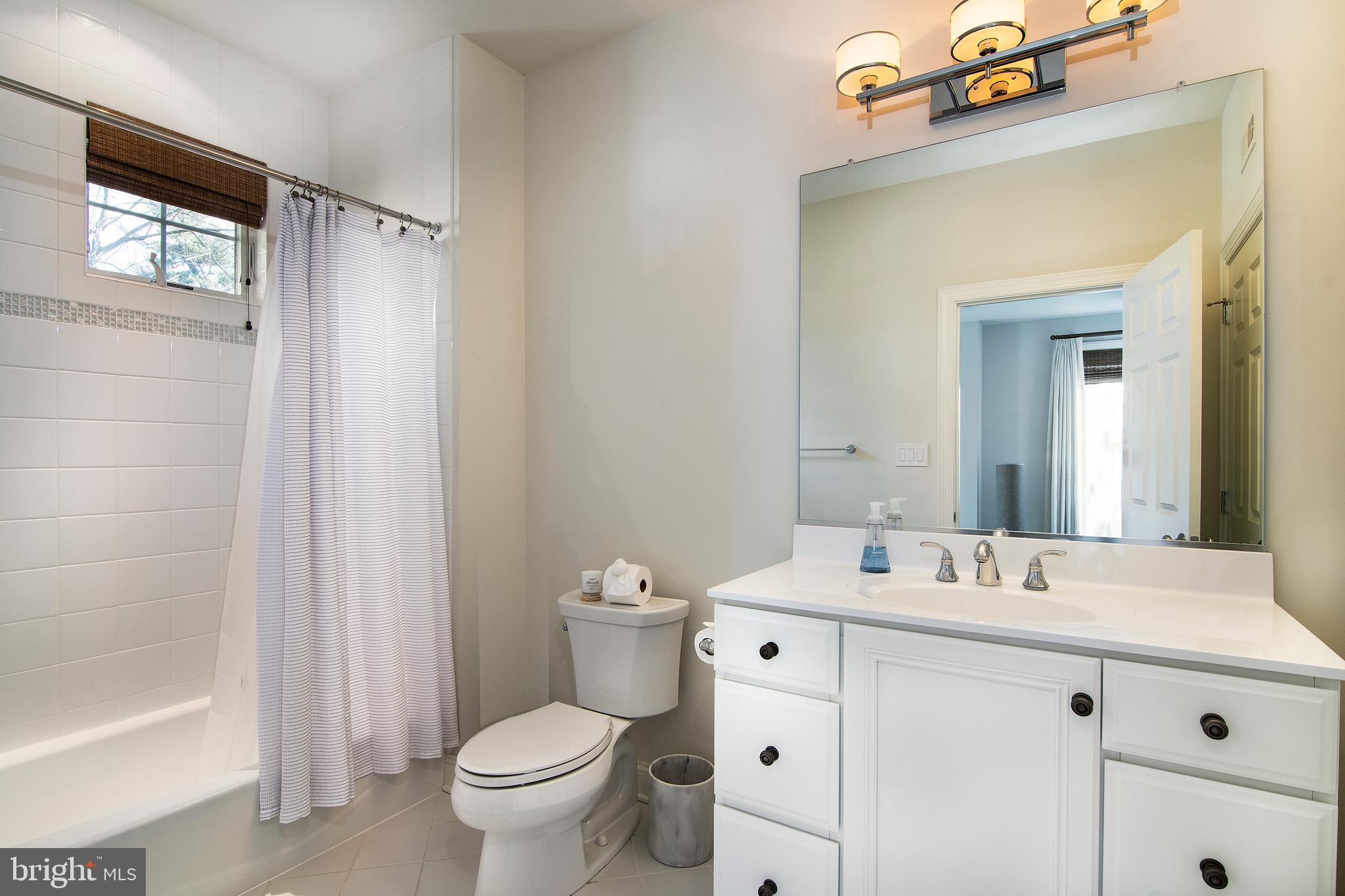 1428 County Line Road Bryn Mawr, PA 19010 - Photo 24 of 31 a bathroom with a sink a toilet a mirror and shower