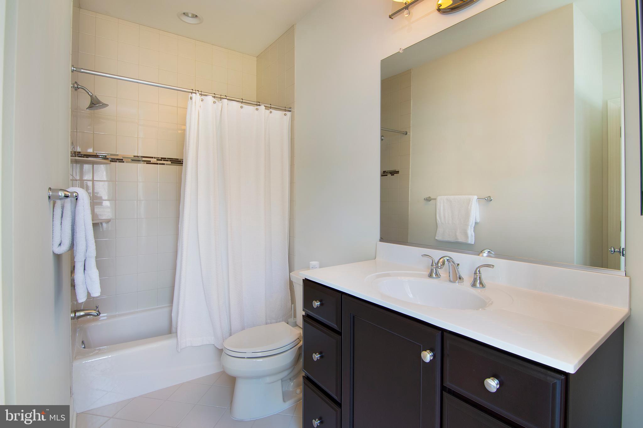 1428 County Line Road Bryn Mawr, PA 19010 - Photo 27 of 31 a bathroom with a sink a toilet and shower