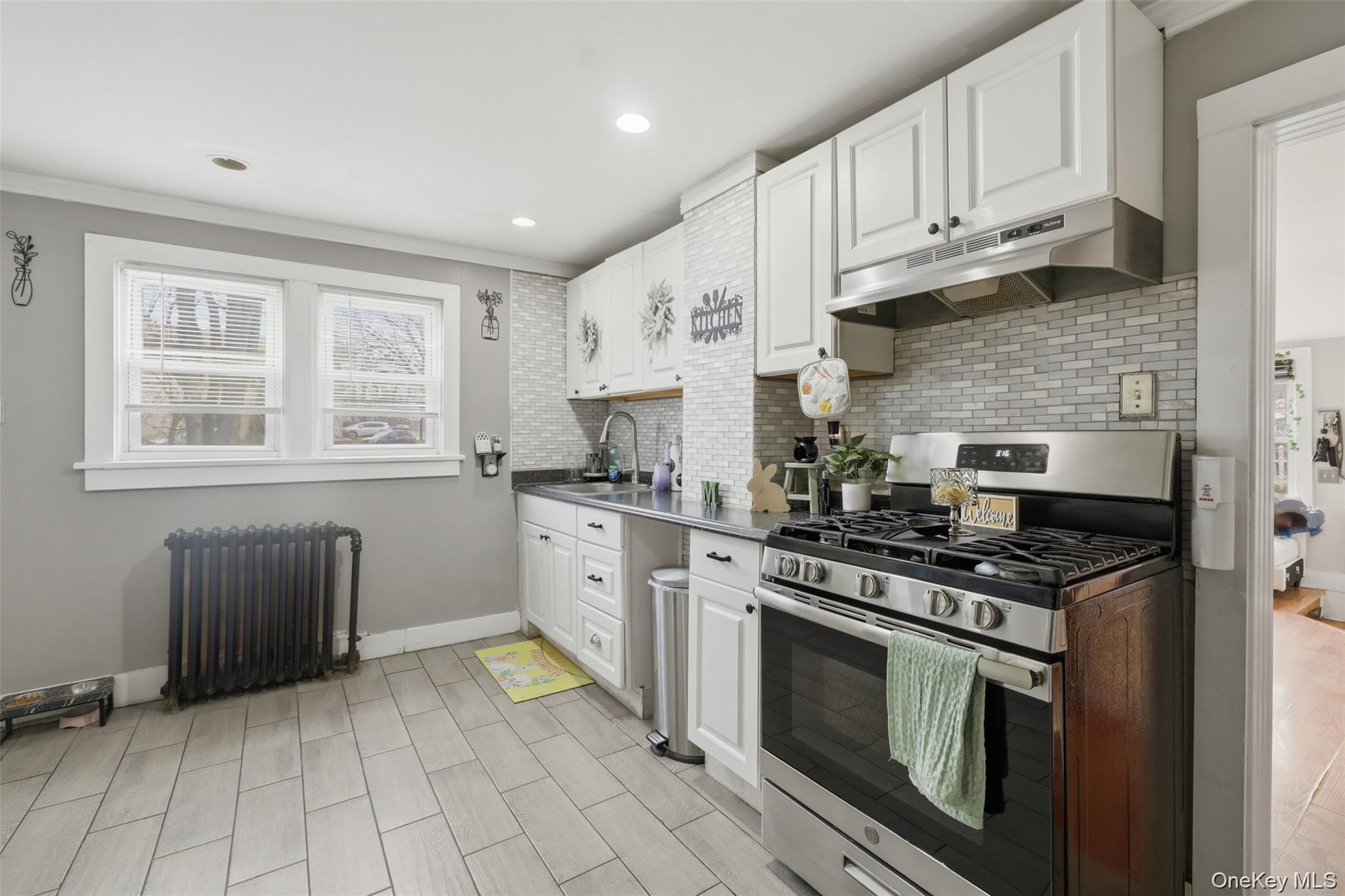 121 Little Britain Road Newburgh, NY 12550 - Photo 8 of 15 a kitchen with stainless steel appliances granite countertop a stove a sink and a microwave