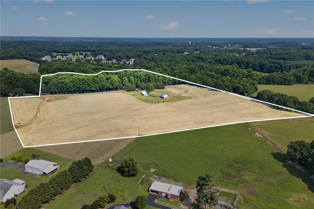 145 State Rd S-4-935 Pendleton, SC 29670 - Photo 7 of 10 An aerial perspective reveals a vast expanse of verdant land, showcasing its potential for development amidst a peaceful rural setting.