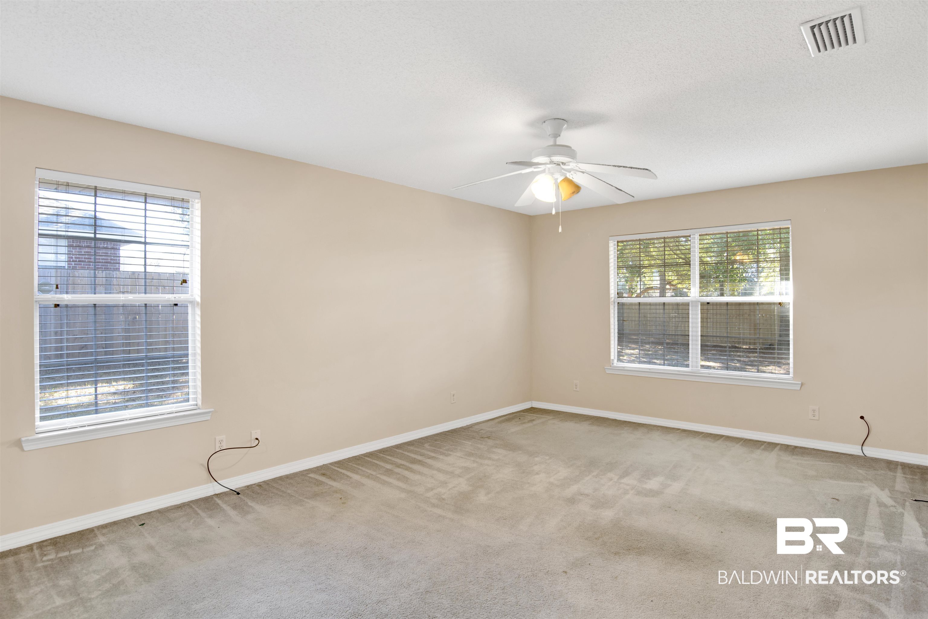 7297 Bridgemill Drive Mobile, AL 36619 - Photo 21 of 33 Spare room with light colored carpet, a ceiling fan, and a textured ceiling