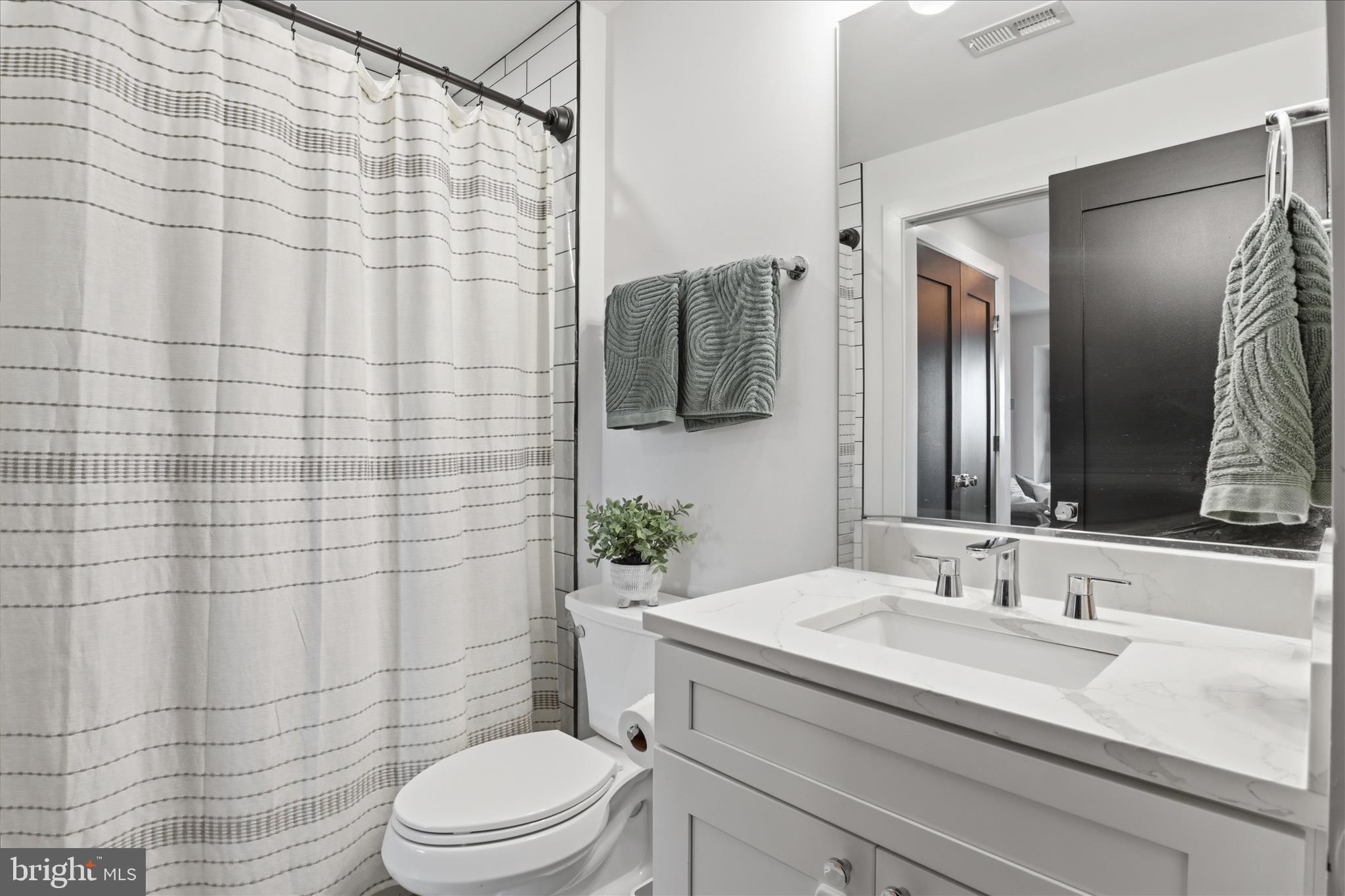 1222 Neal Street Northeast, Unit 3 Washington, DC 20002 - Photo 27 of 38 a bathroom with a sink toilet and shower