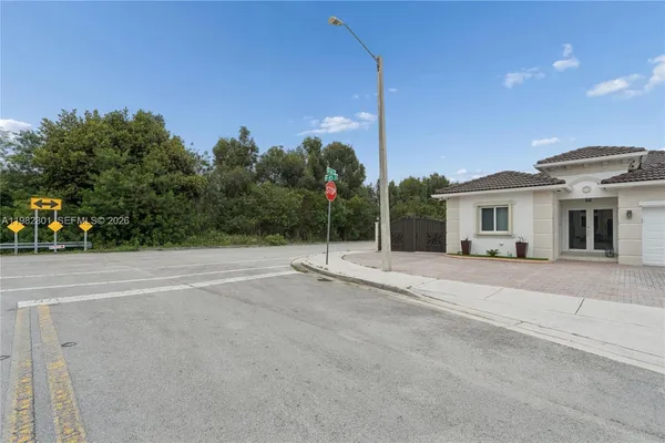 a backyard of a house with portable swimming pool and trees