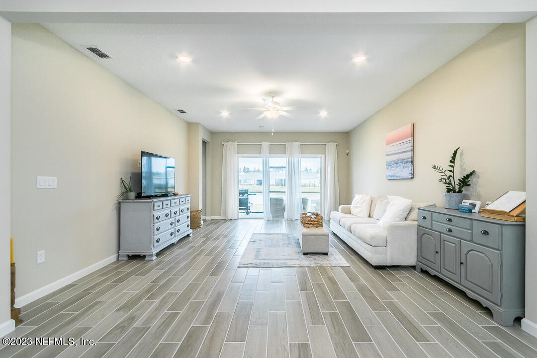 75751 Spoonbill Lane Yulee, FL 32097 - Photo 5 of 19 a living room with furniture and a flat screen tv