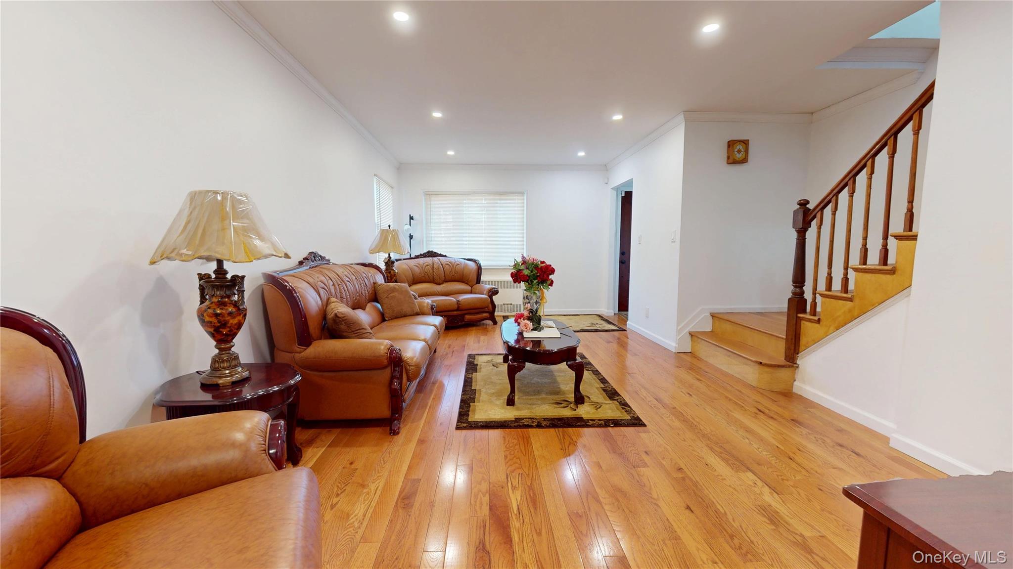 219-42 141st Road Queens, NY 11413 - Photo 14 of 23 a living room with furniture and a wooden floor
