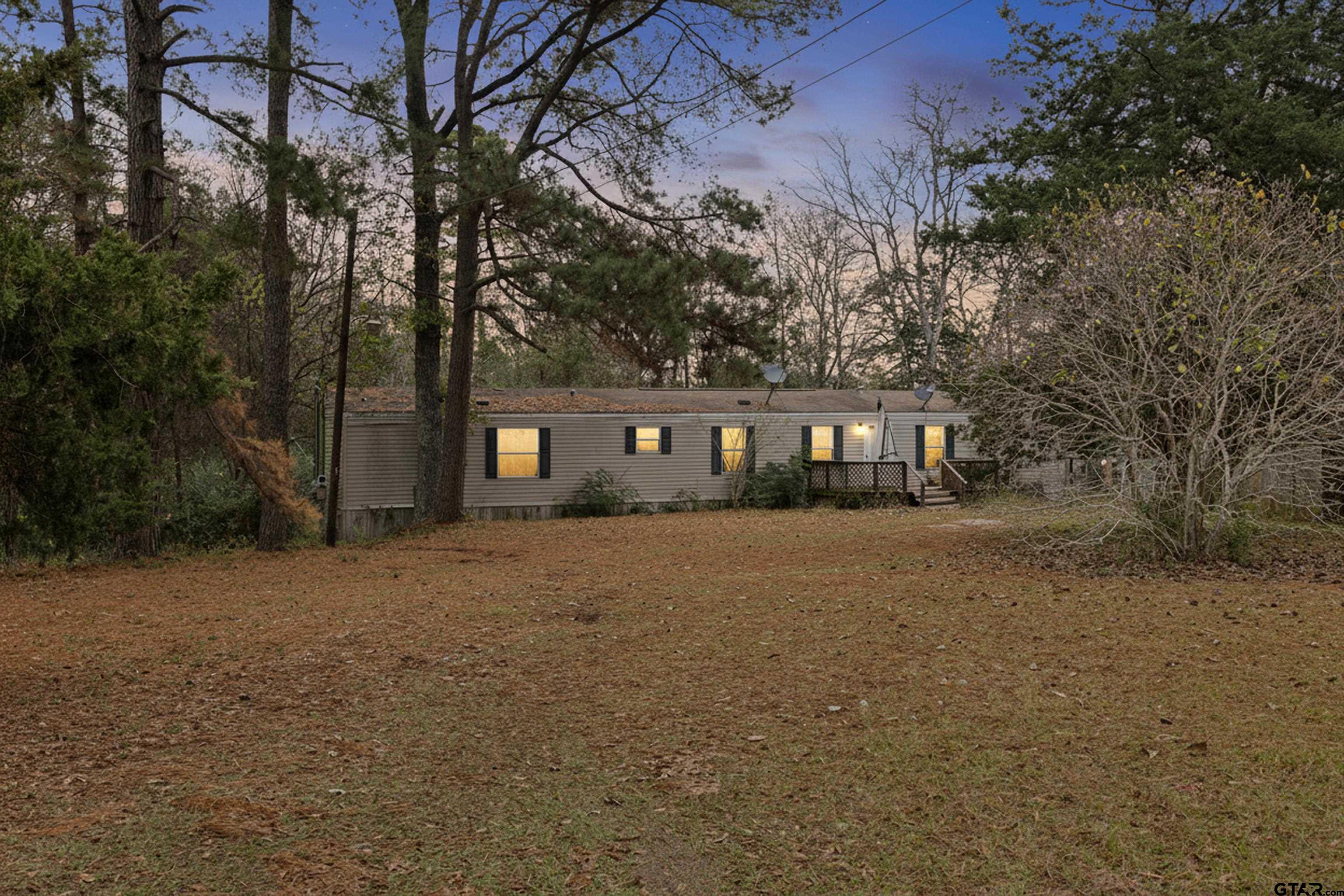 a front view of a house with a tree