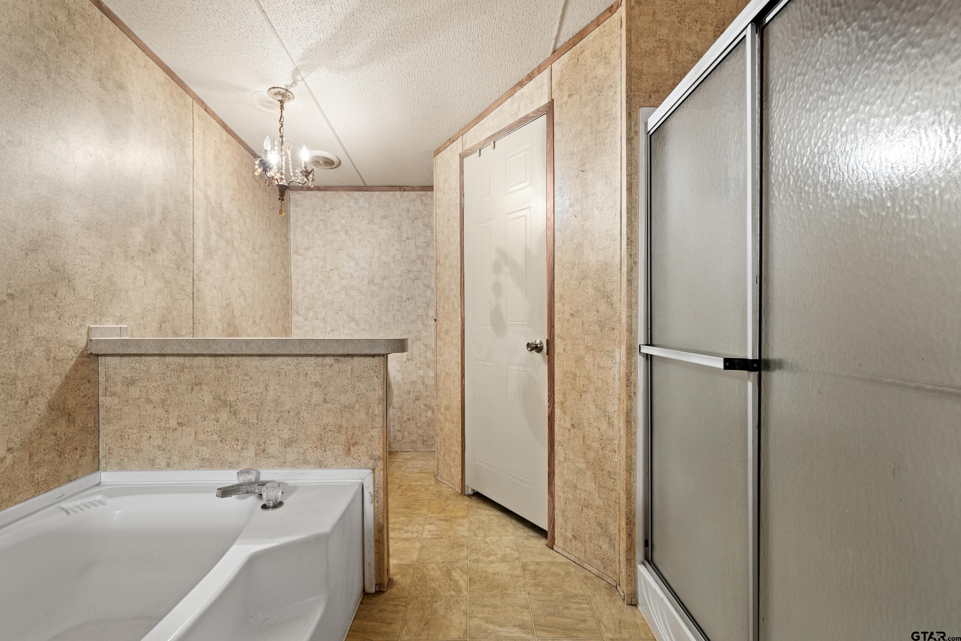200 County Road 2123 Longview, TX 75603 - Photo 15 of 22 a bathroom with a tub and shower