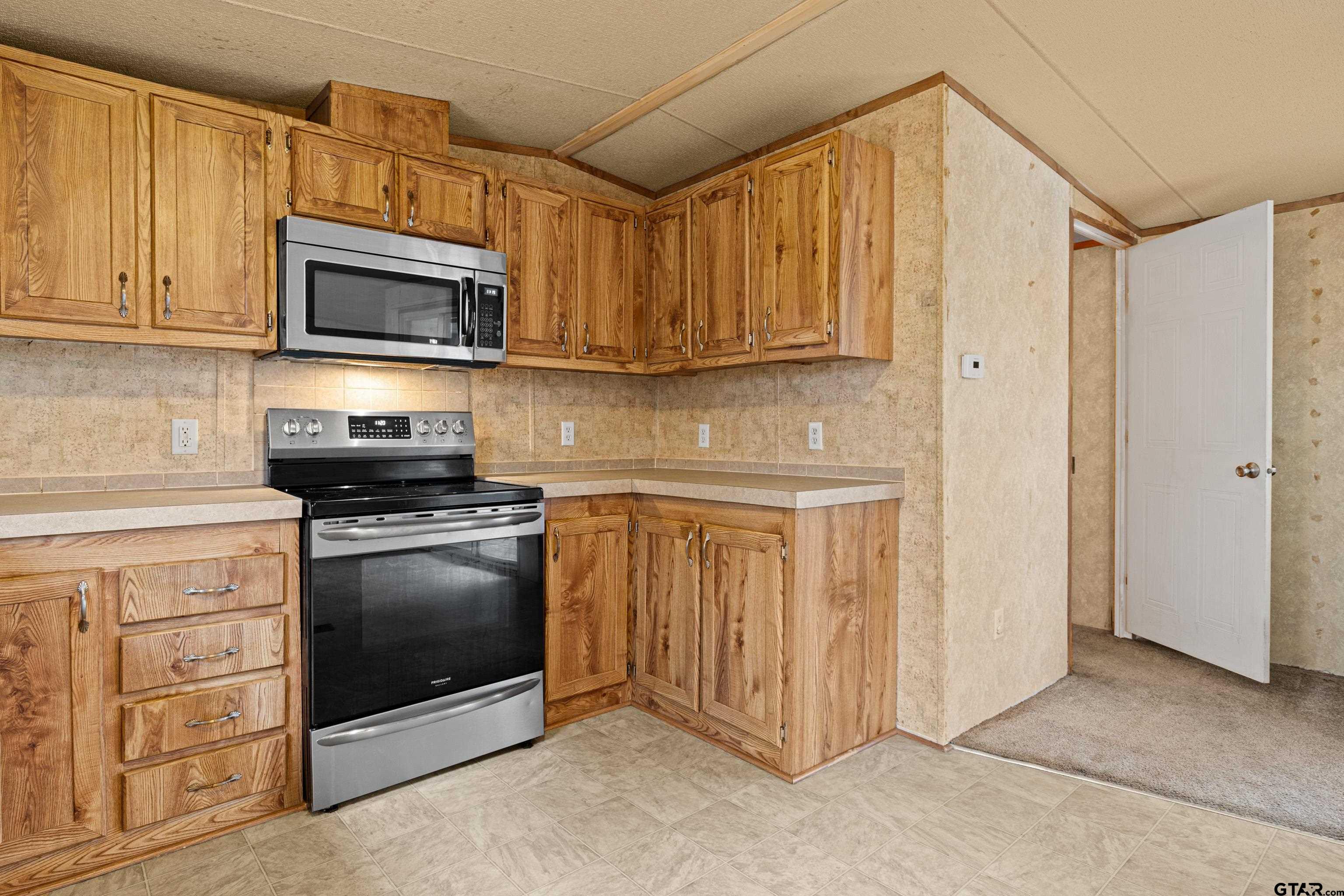 200 County Road 2123 Longview, TX 75603 - Photo 10 of 22 a kitchen with stainless steel appliances granite countertop a refrigerator stove and microwave