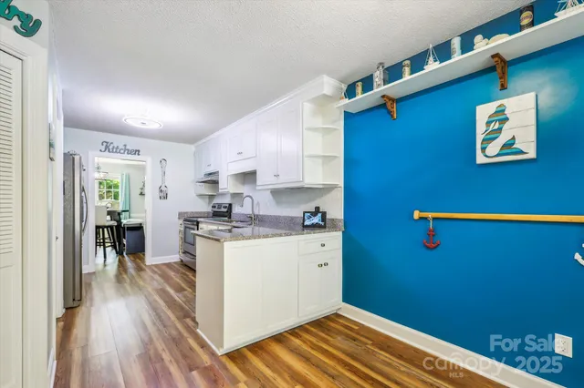 a kitchen with a wooden floor and a window