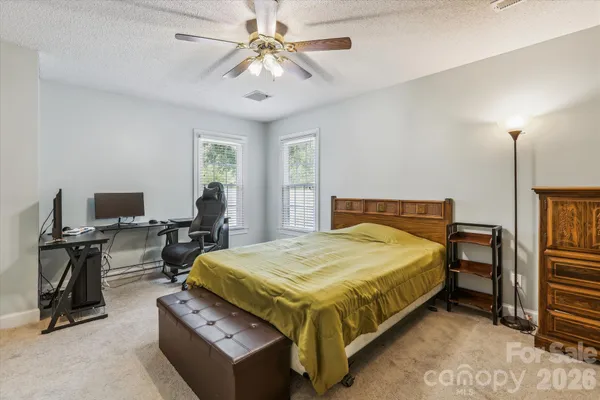 a bedroom with a bed and a desk