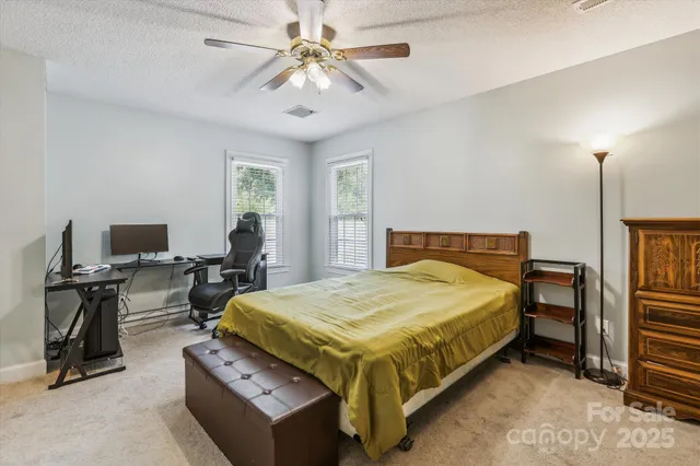 a bedroom with a bed and a desk