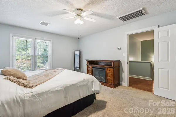 a bedroom with a bed and a fireplace