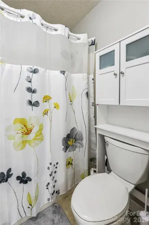 a white toilet sitting next to a bathroom sink and a bathtub