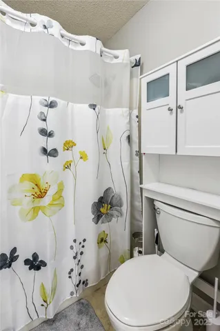 a white toilet sitting next to a bathroom sink and a bathtub