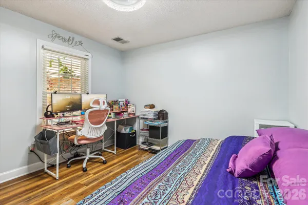 a workspace with furniture and a wooden floor