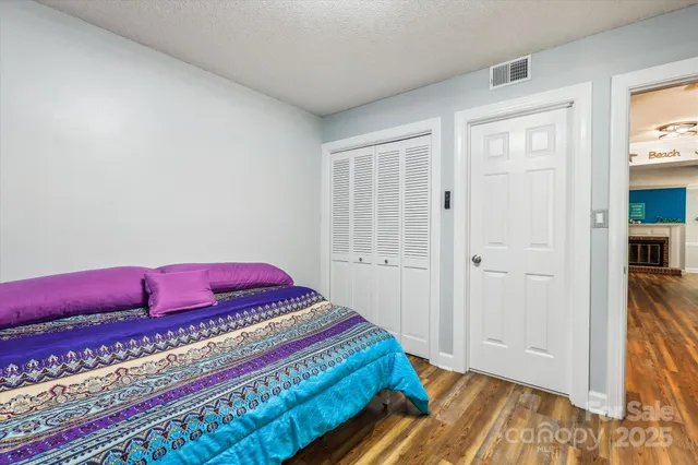 a bedroom with a bed and a book shelf